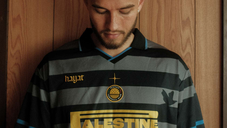 Man wearing black and gold Gaza 4 Ever vintage football jersey from Hayat Clothing